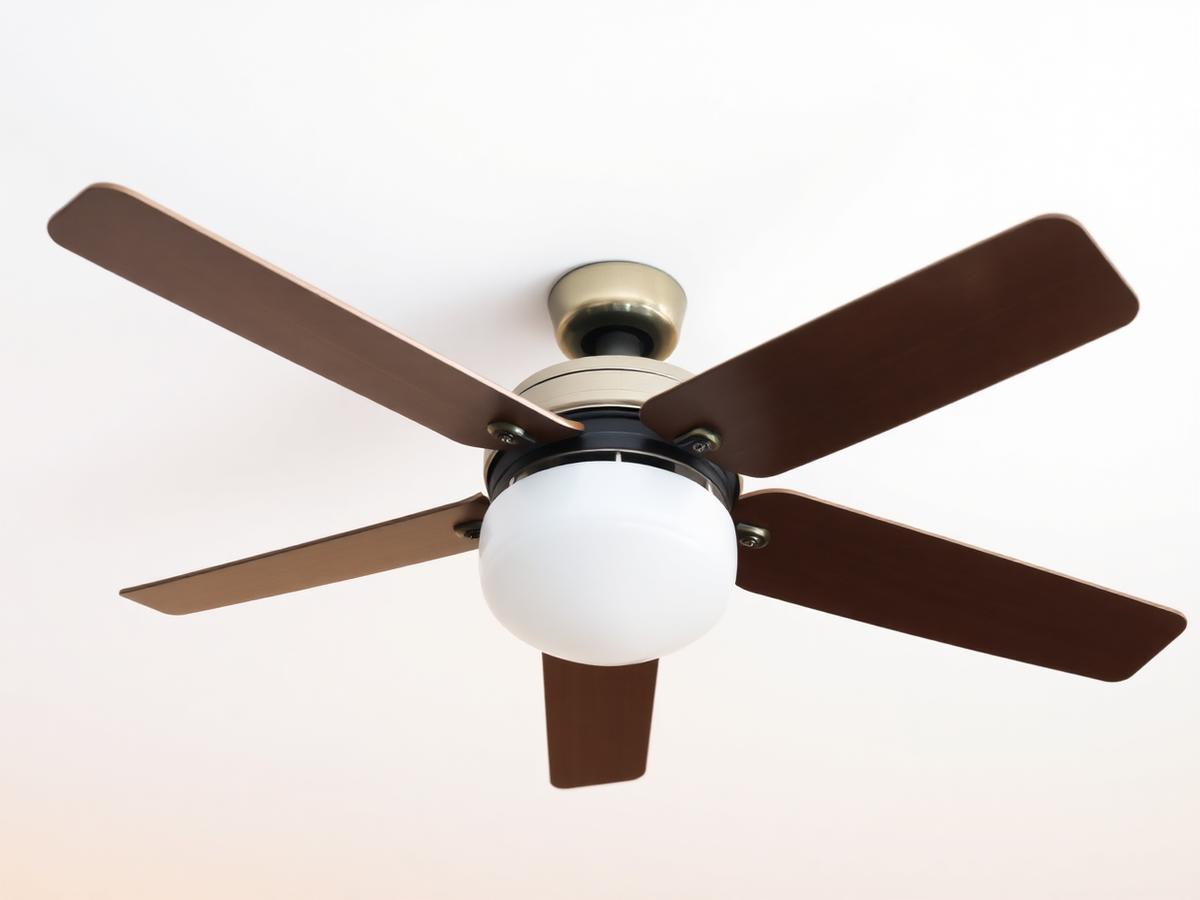 Ceiling fan being installed in a bright room
